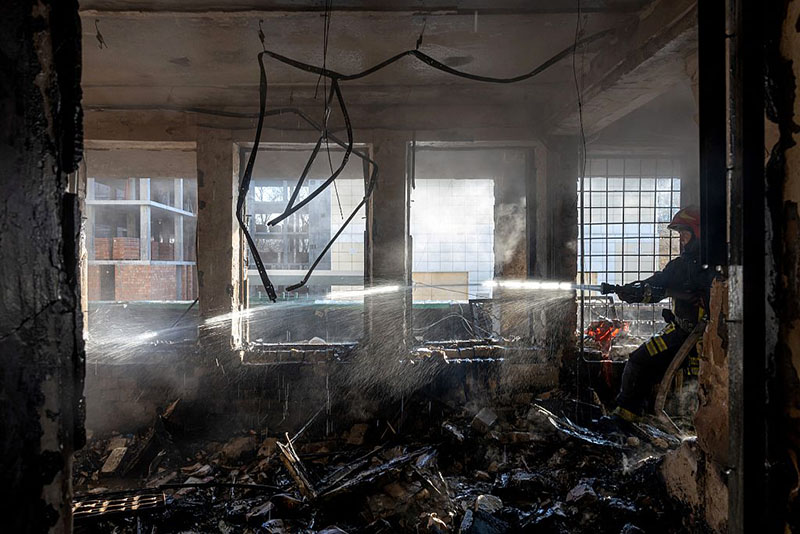 A Ukrainian rescuer works to extinguish a fire in a damaged building following an air attack in Odesa on January 13, 2026, amid the Russian invasion in Ukraine. (Photo by Oleksandr GIMANOV / AFP via Getty Images)