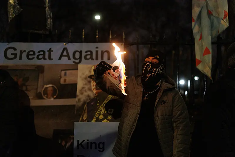 A protester burns an image of Ali Khamenei, Supreme Leader of Iran during a protest outside the Iranian Embassy on January 14, 2026 in London, England. (Photo by Dan Kitwood/Getty Images)